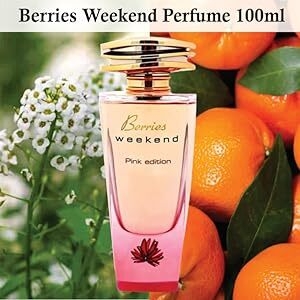 Berries Weekend Perfume, 100ml pink bottle. Surrounded by citrus fruits and white flowers, suggesting a fruity-floral scent.