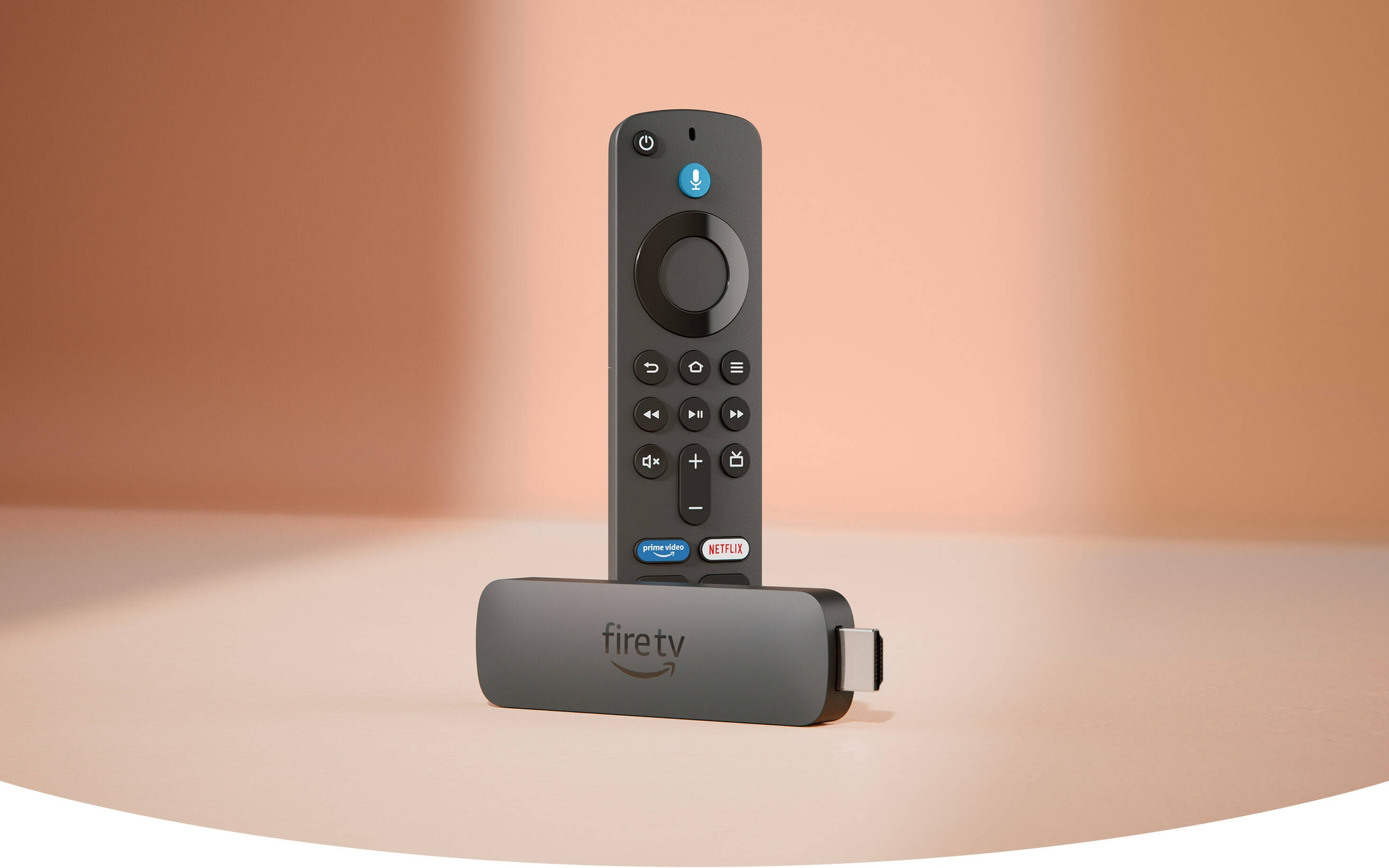 Fire TV Stick 4K Plus: rectangular device with an HDMI connector on one end and a USB-C socket on the side, with Fire TV Alexa Voice Remote, with a navigation ring and buttons on the front and a rounded back.