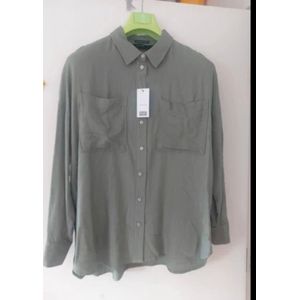 Top linen sea green oversize shirt featuring front patch pockets and long cuffed sleeves. 
