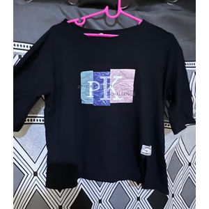 Top black graphic t-shirt featuring a "PK CHALLENGE" design.
